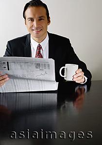 Asia Images Group - Businessman with newspaper and mug, smiling at camera