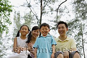 Asia Images Group - Family of four outdoors, smiling at camera