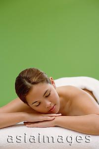 Asia Images Group - Young woman lying on massage table, eyes closed