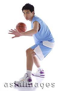 Asia Images Group - Young man playing basketball