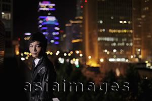 Asia Images Group - Young man walking on the streets at night