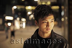 Asia Images Group - Head shot of a young man at night