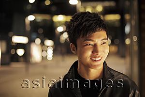 Asia Images Group - Head shot of young man at night