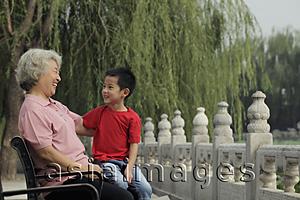 Asia Images Group - Grandmother laughing with her grandson at a park