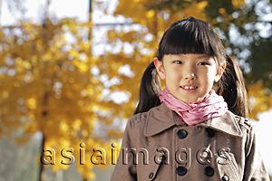 Asia Images Group - Head shot of young girl wearing a coat outdoors