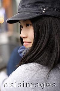 Asia Images Group - Head shot of young woman wearing a cap