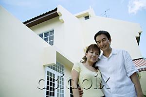 AsiaPix - Couple standing in front of house, arms around each other