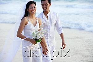 AsiaPix - Newlyweds walking on beach, smiling