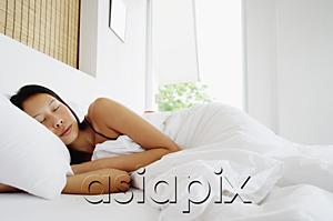 AsiaPix - Woman lying in bed, sleeping