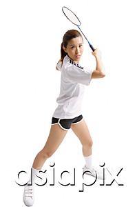 AsiaPix - Young woman holding badminton racket, waiting to swing