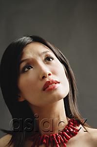AsiaPix - Woman wearing chunky necklace, pensive expression