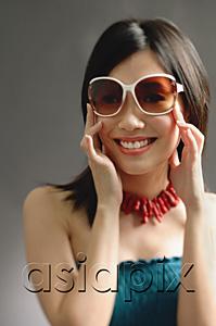 AsiaPix - Woman wearing large sunglasses, smiling at camera