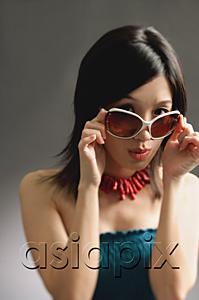 AsiaPix - Woman adjusting large sunglasses, looking at camera