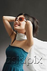 AsiaPix - Woman wearing large sunglasses, tube top and scarf, smiling