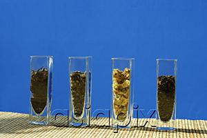 AsiaPix - Tea leaves in glass containers, in a row