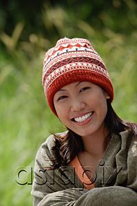 AsiaPix - Woman with ski cap, wrapped in a blanket