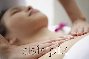 AsiaPix - Young woman getting a massage, close up on masseuses hands